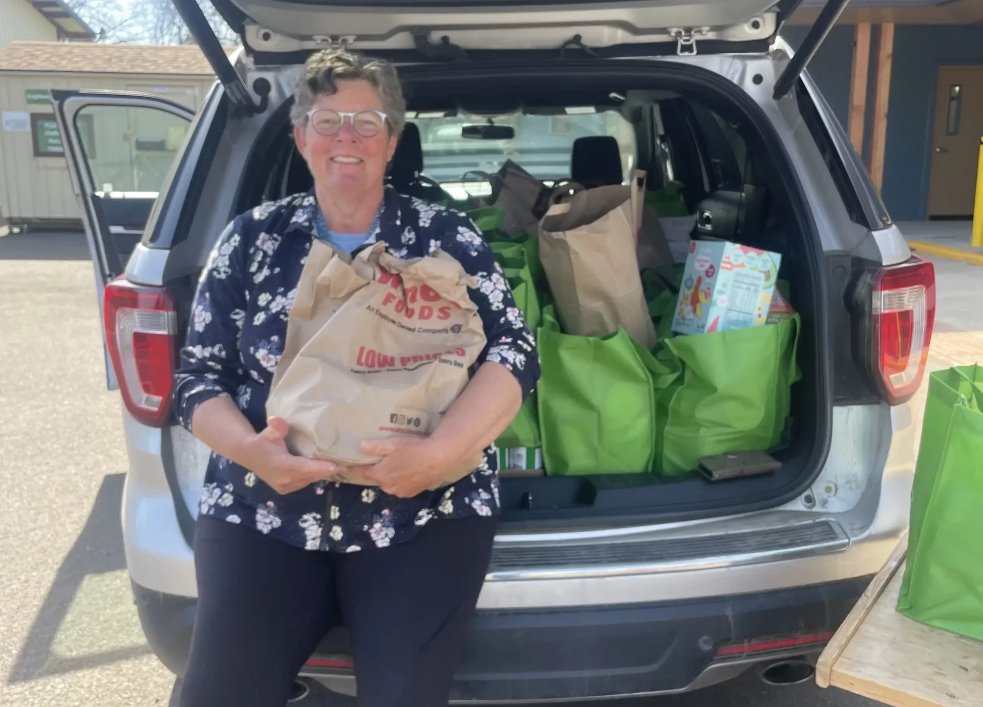 Yamhill County Food Project Volunteer With Green Bag of Donating Food