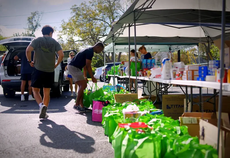 NCs dropping off their neighborhood's green bags and collection day volunteers organizing them